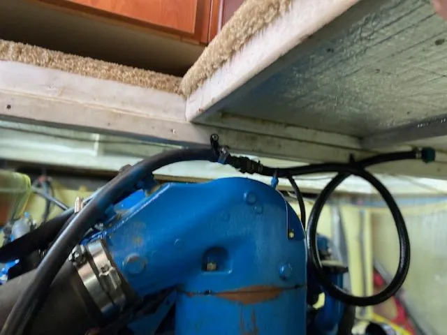 Slide: The Image of Engine compartment of a 2007 Silverton 33 Convertible boat with visible blue engine components. - 21