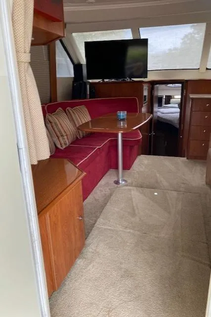 Slide: The Image of Interior of 2007 Silverton 33 Convertible yacht with red sofa and TV. - 24