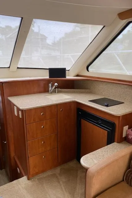 Slide: The Image of 2007 Silverton 33 Convertible yacht interior with kitchenette and wood cabinetry. - 26