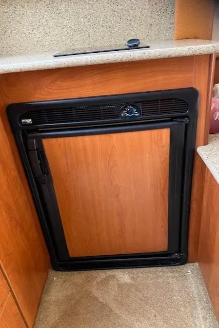 Slide: The Image of 2007 Silverton 33 Convertible boat interior with a compact refrigerator. - 27