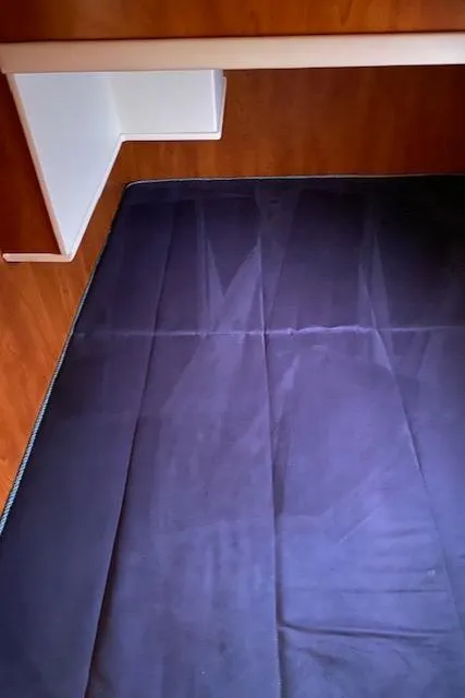 Slide: The Image of Interior cabin of a 2007 Silverton 33 Convertible boat with a dark mattress. - 34