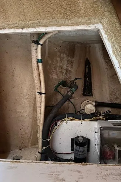 Slide: The Image of Engine compartment of a 2007 Silverton 33 Convertible boat showing pipes and wiring. - 35