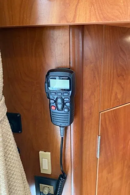 Slide: The Image of VHF radio mounted on 2007 Silverton 33 Convertible yacht's wooden interior. - 38