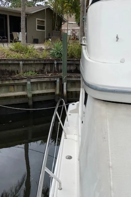 Slide: The Image of 2007 Silverton 33 Convertible docked near a waterfront home. - 5