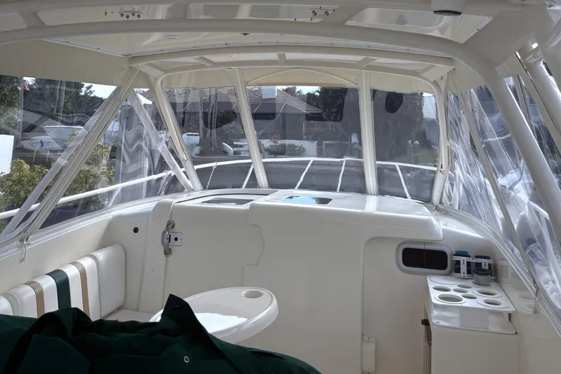 Slide: The Image of 2004 Intrepid 377 Walkaround boat interior with seating and clear canopy. - 10