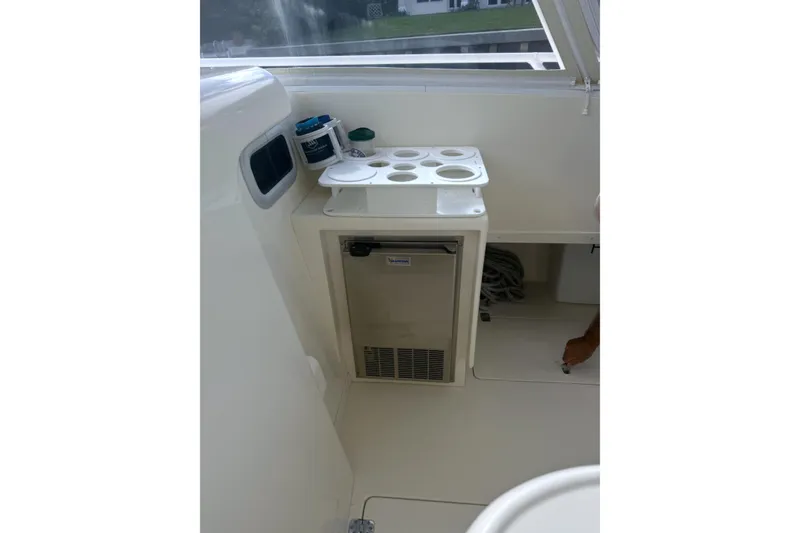 Slide: The Image of 2004 Intrepid 377 Walkaround interior with mini fridge and cup holders. - 11