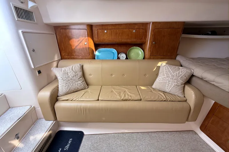 Slide: The Image of 2004 Intrepid 377 Walkaround interior with beige sofa, decorative pillows, and wooden cabinets. - 15