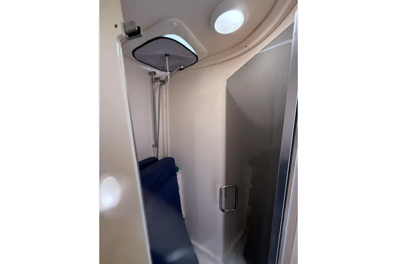 Slide: The Image of Shower area inside a 2004 Intrepid 377 Walkaround boat, featuring a sleek design. - 20