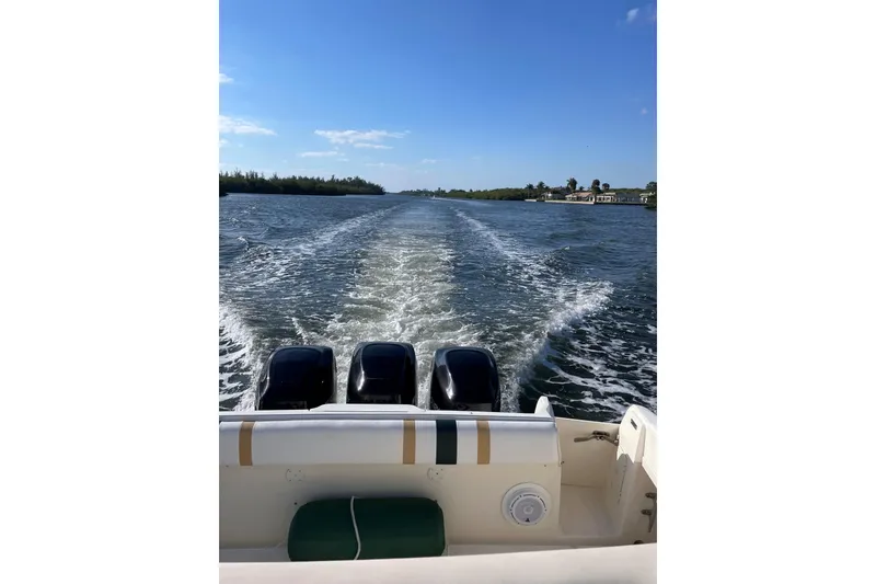 Slide: The Image of 2004 Intrepid 377 Walkaround boat cruising on a sunny day, leaving a wake behind. - 23