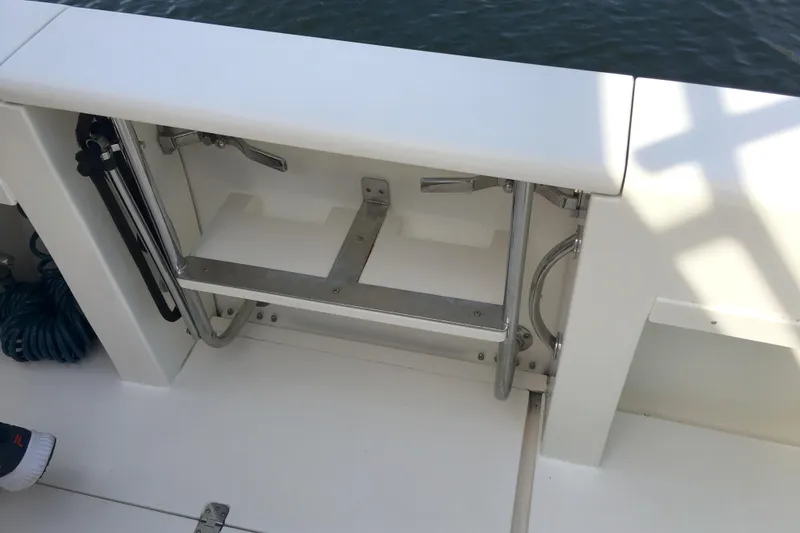 Slide: The Image of 2004 Intrepid 377 Walkaround boat ladder compartment with stainless steel fittings. - 8
