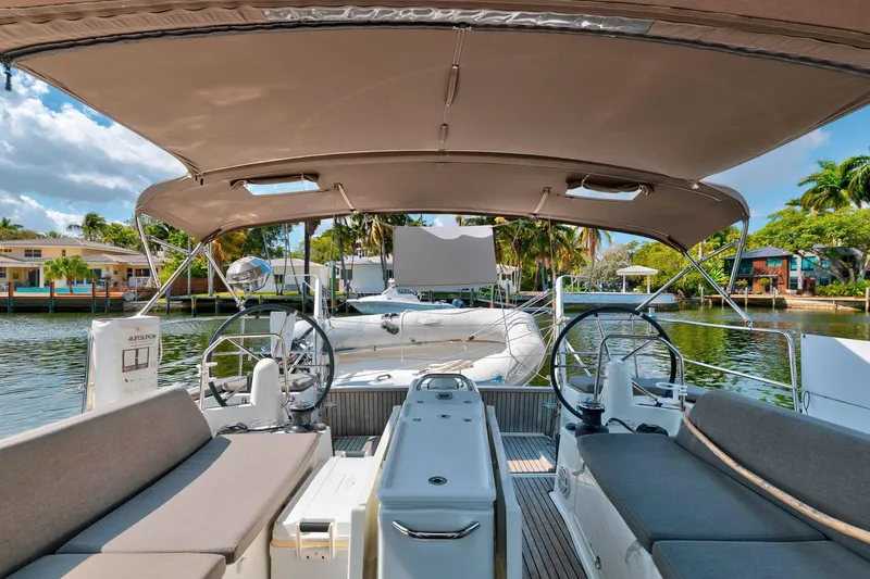 Slide: The Image of 2021 Jeanneau Sun Odyssey 440 yacht cockpit with dual steering wheels and comfortable seating. - 10