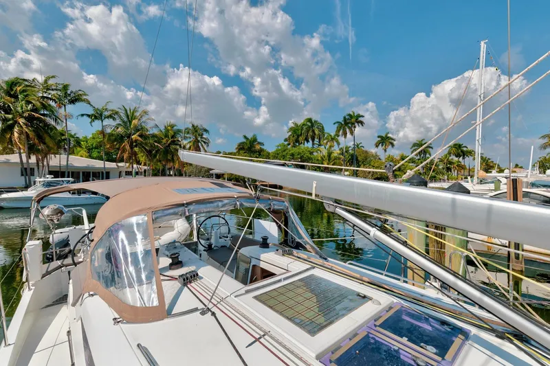 Slide: The Image of Jeanneau Sun Odyssey 440 sailboat docked, 2021 model, with palm trees and blue sky background. - 20