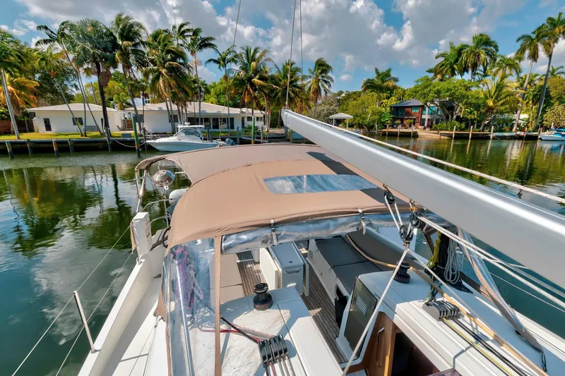 Slide: The Image of Jeanneau Sun Odyssey 440 sailboat docked by palm trees, 2021 model. - 23