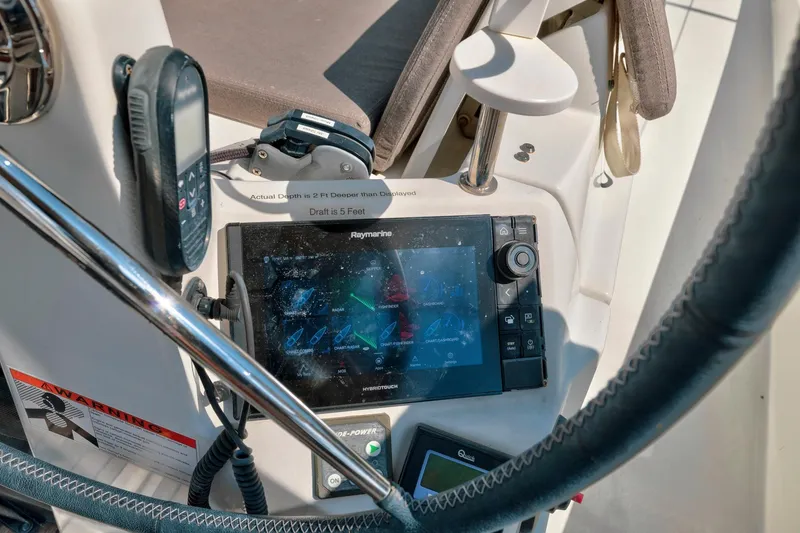 Slide: The Image of Cockpit of 2021 Jeanneau Sun Odyssey 440 with navigation equipment and controls. - 26