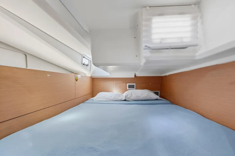 Slide: The Image of Cozy cabin interior of 2021 Jeanneau Sun Odyssey 440 sailboat with a comfortable bed. - 44