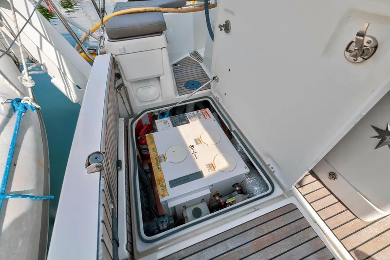 Slide: The Image of Jeanneau Sun Odyssey 440 (2021) engine compartment with open hatch, showcasing equipment and storage. - 51