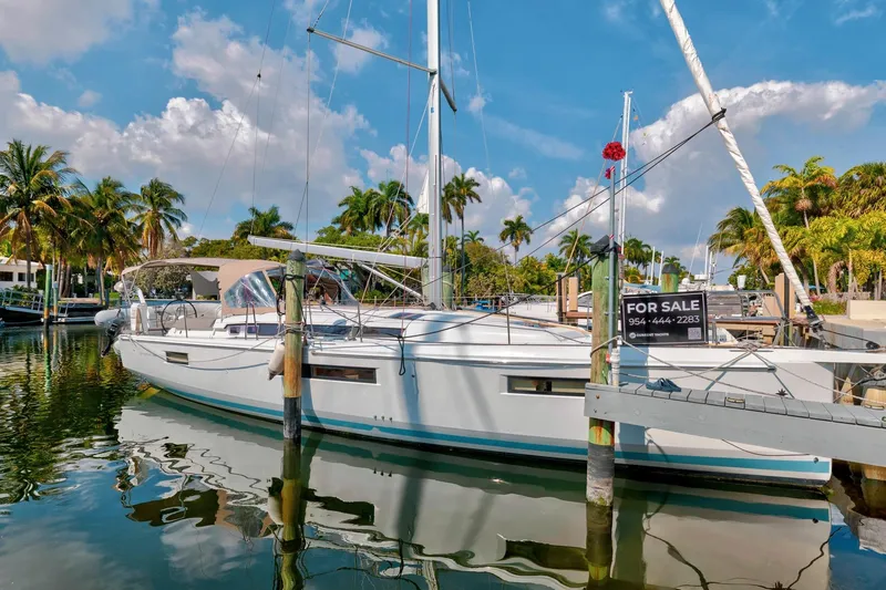 Slide: The Image of 2021 Jeanneau Sun Odyssey 440 sailboat for sale, docked in a tropical marina. - 7