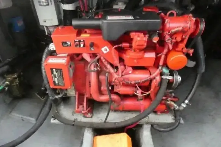 Slide: The Image of Engine compartment of a 2001 Sea Ray Sundancer 310 boat, featuring a red marine engine. - 14