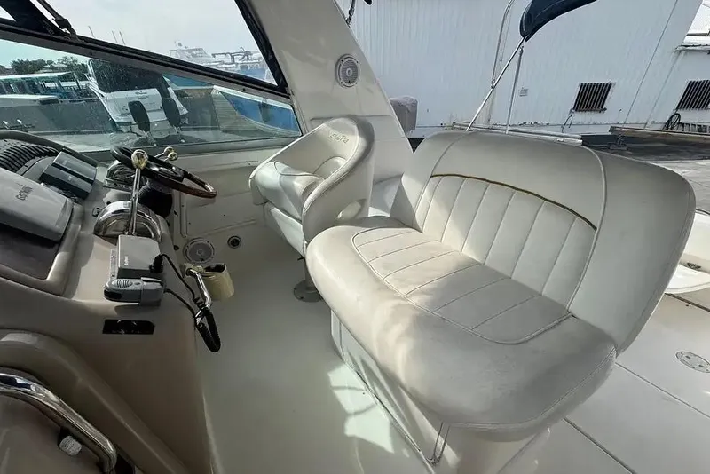 Slide: The Image of 2001 Sea Ray Sundancer 310 cockpit with steering wheel and cushioned seating. - 5