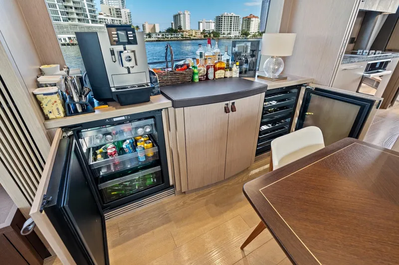 Slide: The Image of Luxurious Sunseeker 86 Yacht interior with minibar, coffee machine, and waterfront view, 2019 model. - 13