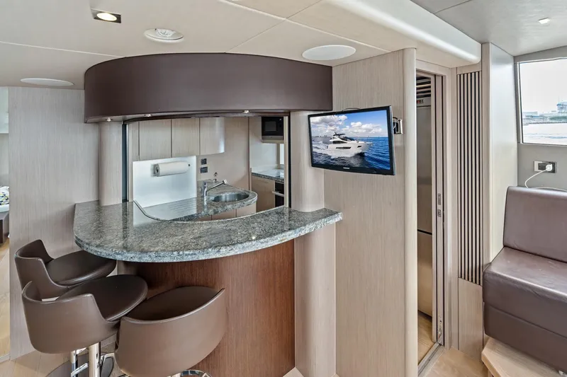 Slide: The Image of Luxurious interior of 2019 Sunseeker 86 Yacht with modern bar and seating area. - 14