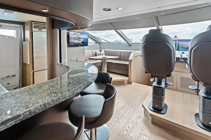 Slide: The Image of Luxurious interior of 2019 Sunseeker 86 Yacht with modern helm and seating area. - 16