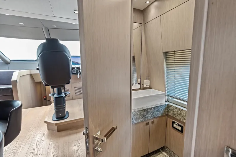 Slide: The Image of Luxurious interior of 2019 Sunseeker 86 Yacht with helm and modern bathroom. - 17
