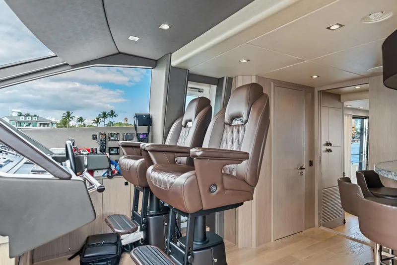 Slide: The Image of Luxurious interior of 2019 Sunseeker 86 Yacht with plush captain's chairs and modern controls. - 18