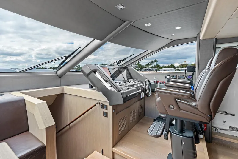 Slide: The Image of Luxurious helm of 2019 Sunseeker 86 Yacht with modern controls and leather seating. - 19