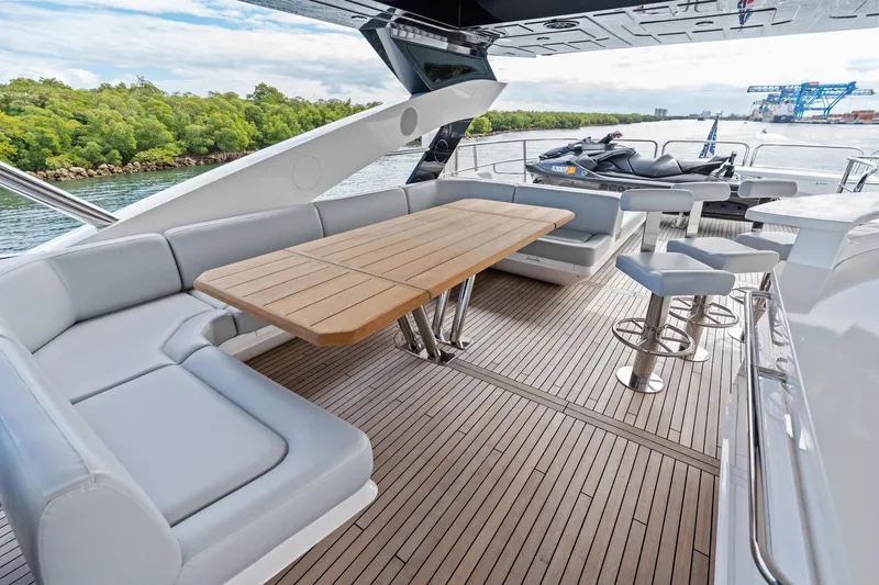 Slide: The Image of Luxurious 2019 Sunseeker 86 Yacht deck with seating, table, and scenic water view. - 34