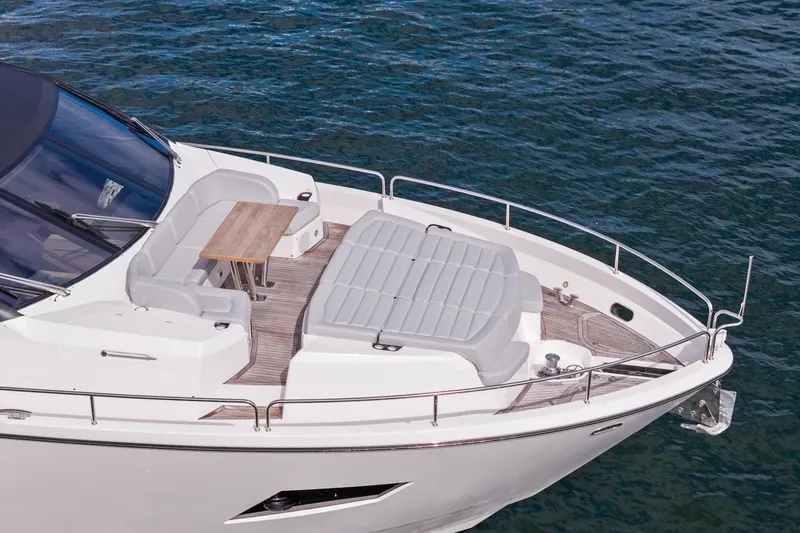 Slide: The Image of Luxurious 2019 Sunseeker 86 Yacht with elegant deck seating and table on calm waters. - 37