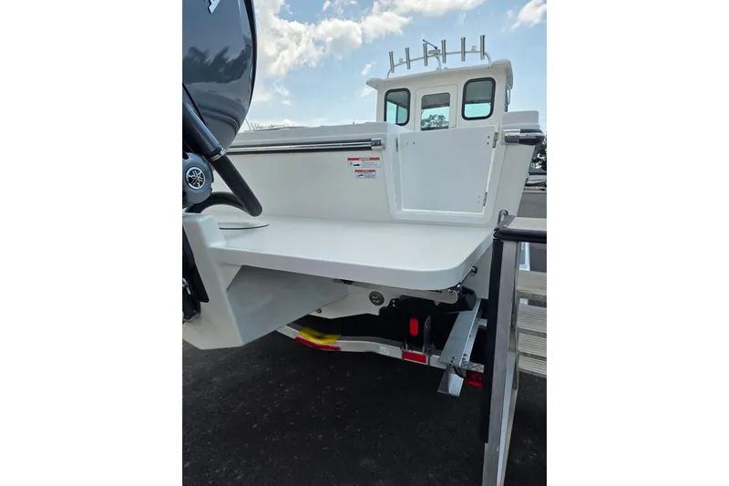 Slide: The Image of 2026 Parker 247 Explorer boat rear view with motor and ladder. - 10