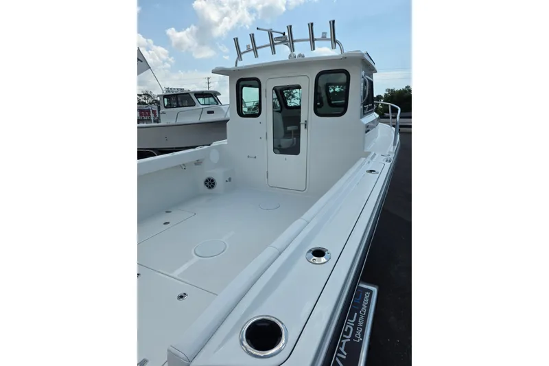 Slide: The Image of 2026 Parker 247 Explorer boat with spacious deck and modern design under a clear sky. - 11