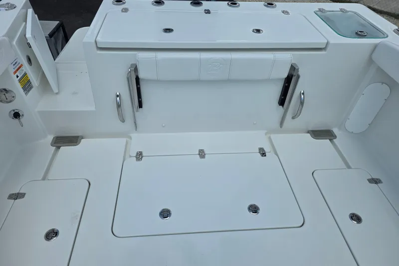 Slide: The Image of 2026 Parker 247 Explorer boat deck with storage compartments and seating. - 12