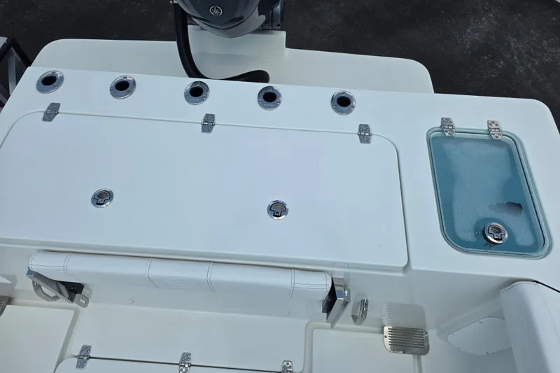 Slide: The Image of Rear deck of 2026 Parker 247 Explorer boat with storage compartments and rod holders. - 13