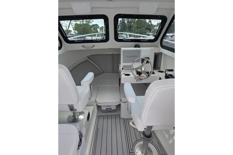 Slide: The Image of Interior of 2026 Parker 247 Explorer boat with modern helm and seating. - 15
