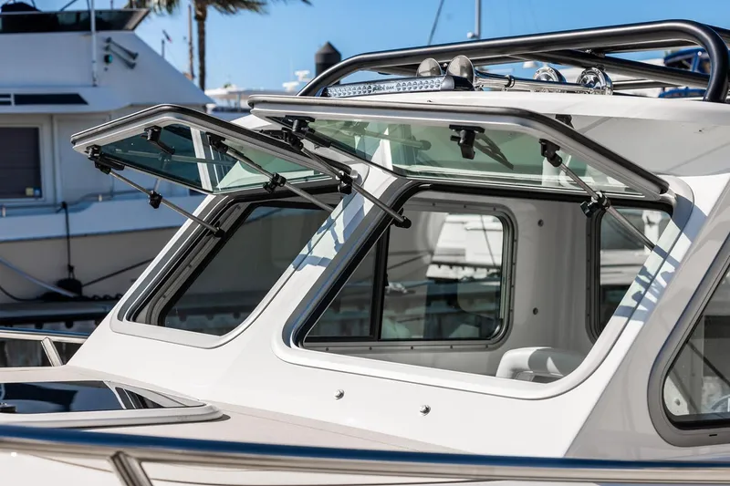 Slide: The Image of Manufacturer Provided Image: 2026 Parker 247 Explorer boat with open windows, showcasing sleek design and modern features. - 2