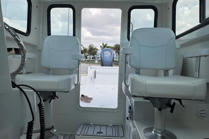Slide: The Image of Interior of 2026 Parker 247 Explorer boat with two white captain chairs. - 20