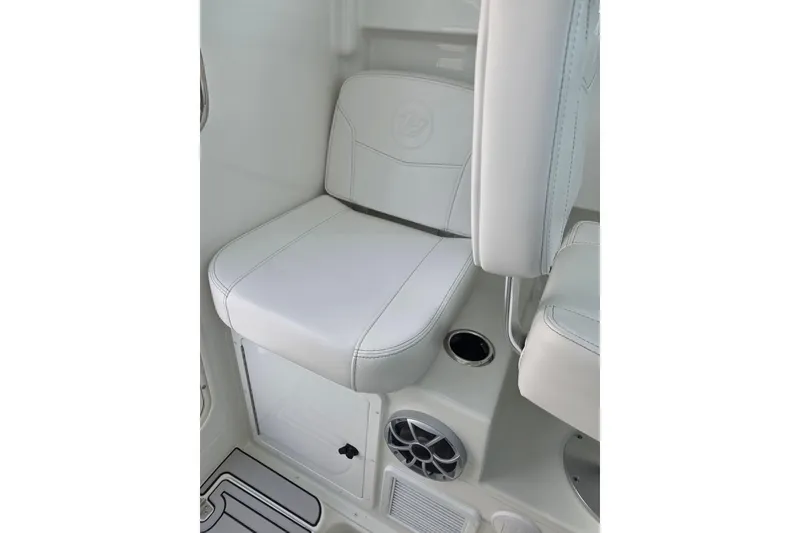 Slide: The Image of White seating area on 2026 Parker 247 Explorer boat, featuring cup holder and speaker. - 24
