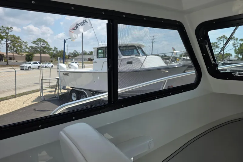 Slide: The Image of Interior view of 2026 Parker 247 Explorer boat, showcasing exterior through windows. - 27