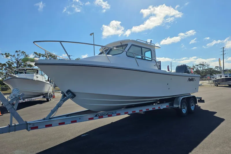Slide: The Image of 2026 Parker 247 Explorer boat on trailer under clear blue sky. - 28