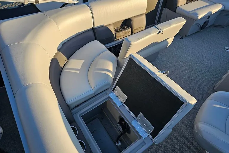 Slide: The Image of 2021 Bentley Pontoons 223 Fish-N-Cruise interior with open storage compartments and cushioned seating. - 12
