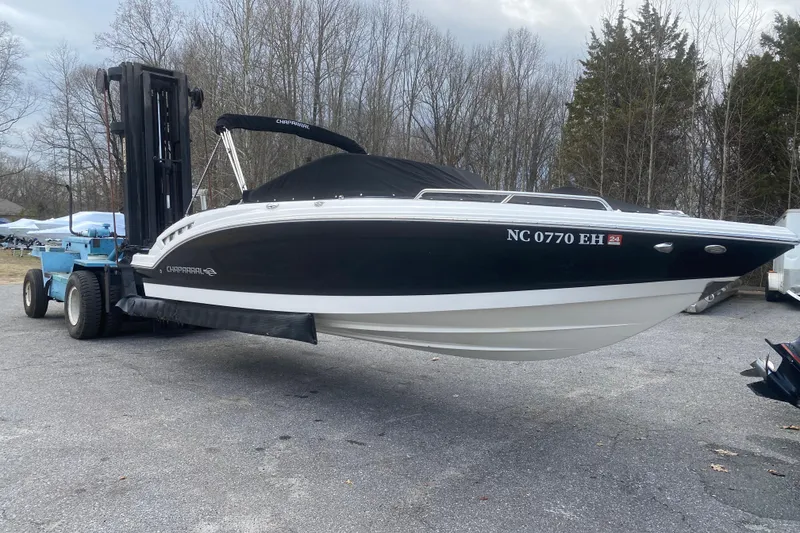 The Image of 2018 Chaparral 227 SSX boat lifted by forklift, parked outdoors. - 0
