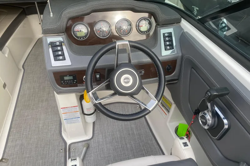 Slide: The Image of 2018 Chaparral 227 SSX boat dashboard with steering wheel and control panel. - 4