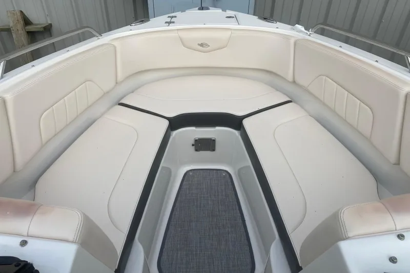 Slide: The Image of 2018 Chaparral 227 SSX boat interior with beige seating and gray flooring. - 5