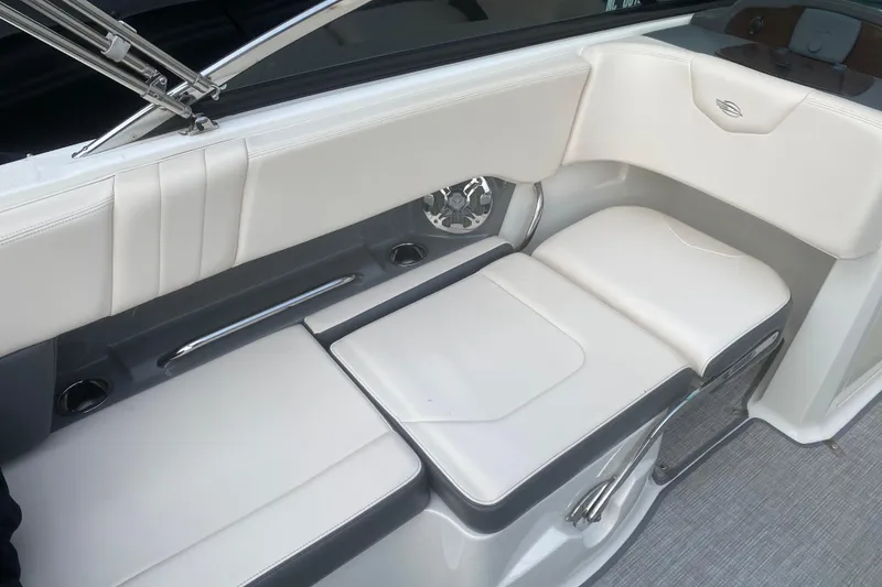 Slide: The Image of 2018 Chaparral 227 SSX boat interior with white cushioned seating and sleek design. - 7