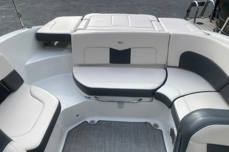 Slide: The Image of 2018 Chaparral 227 SSX boat interior with white and gray seating arrangement. - 8