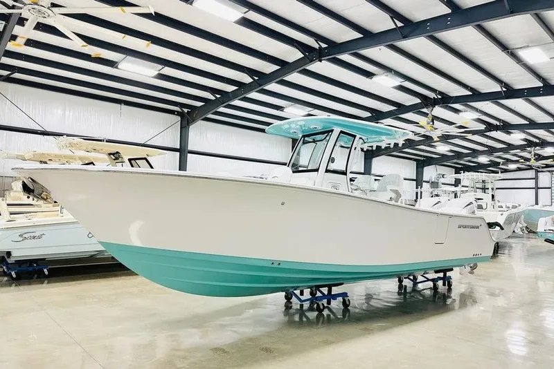 The Image of 2026 Sportsman Heritage 261 Center Console boat in a spacious indoor showroom. - 1