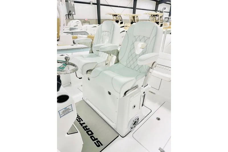 Slide: The Image of 2026 Sportsman Heritage 261 Center Console boat interior with luxurious seating and steering wheel. - 10