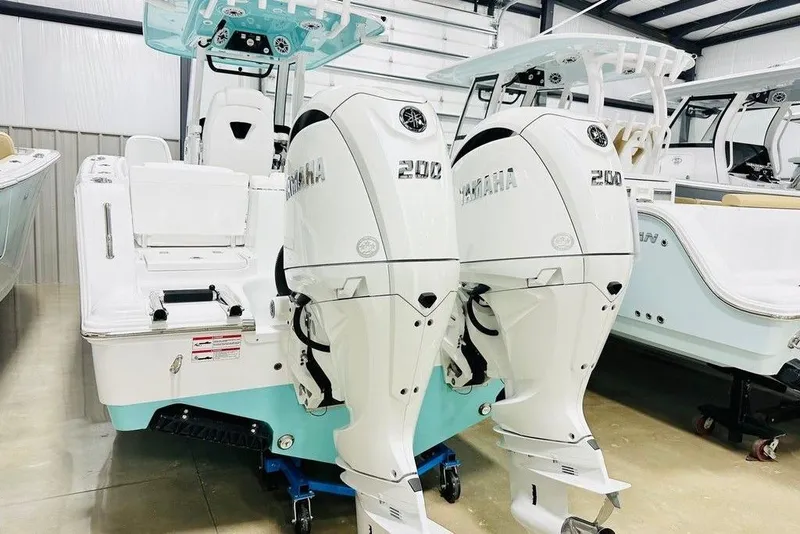 Slide: The Image of 2026 Sportsman Heritage 261 Center Console with twin Yamaha 200 engines in showroom. - 15